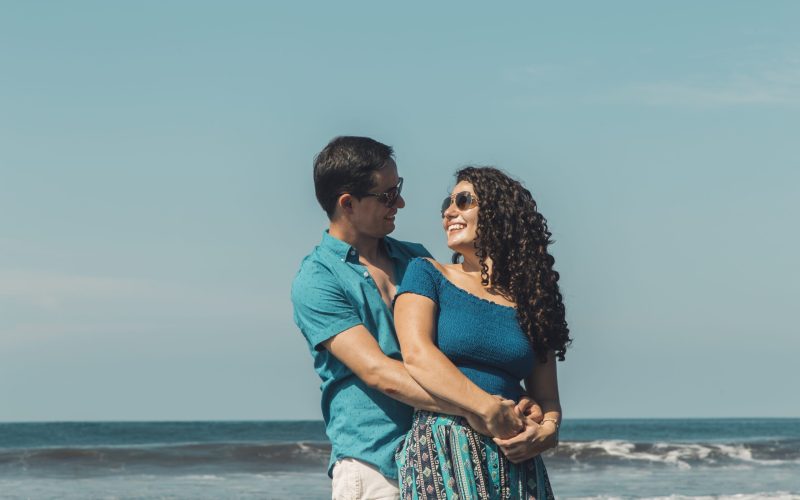 man-hugging-smiling-woman-beach